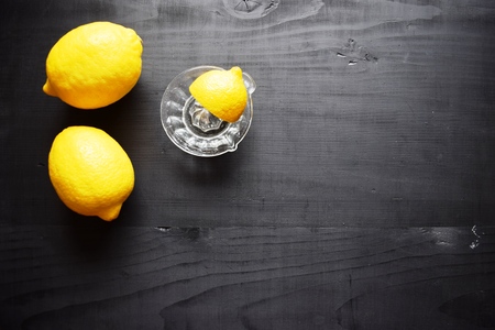 Lemons on a black wooden background. Fruits. The juice of the lemon . Healthy food concept,の写真素材