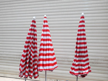 three beach umbrella on street (red and white)の写真素材
