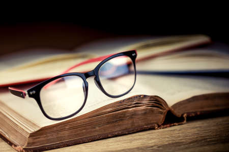 Close up glassess on old books.Education and reading concept.Not too late to learn.の写真素材