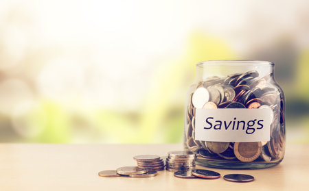 Coins in glass jar save money for business and financial concept.Saving retirement planning for...