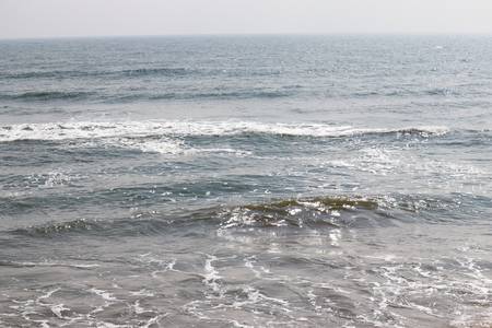 Abstract blur background, nature of tropical summer beach with rays of sun light. Golden sand beach, sea water against blue sky with white clouds. Copy space, summer vacation concept.の写真素材