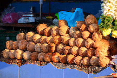 close up shot of many water coconut fruits for selling on the street coconut market against hindu...