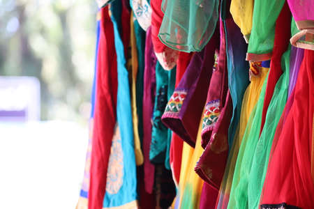 close up of female cloths with many color hanging on street cloths shop in Indian cloths market, street cloths marketの写真素材