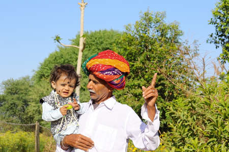A indian grandfather telling his little grandson about natureの写真素材