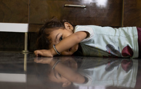 A child watching with an eye and his image formed on a marble stone