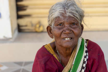 Chennai- Tamilnadu India , 24 July 2020. Old woman sitting near road outside, senior people portraitのeditorial素材