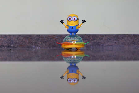 A picture of a child's toy on a transparent marble stone and a reflect image being made below it. (electronic robot )の写真素材