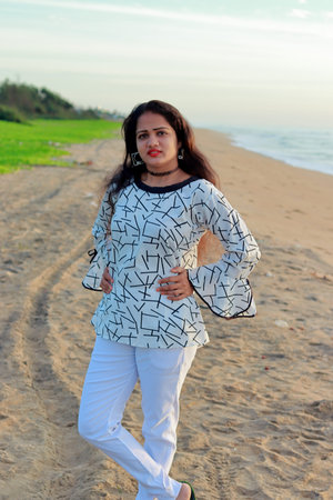 outdoors portrait full body of an indian young model woman stylish posing with beach landscape...