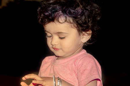 Close-up portrait of an indian fair little hindu boy child on black creative isolated natural background or low key backgroundの写真素材