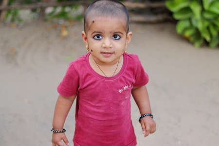 Pali Rajasthan, India. âOctober â28 ,â2021. a cute little girl standing outside looking at the cameraのeditorial素材