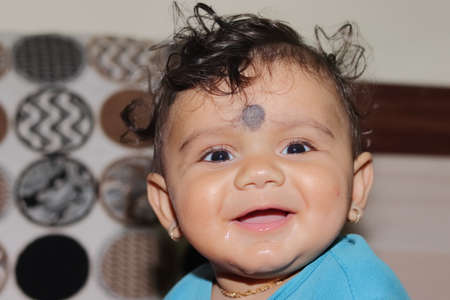 Close-up portrait photo of A lovely cute little Indian hindu baby boy looking at the camera with smiling face, indiaの写真素材