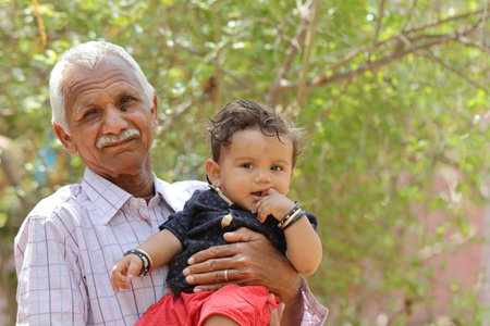 Close-up Photo together with little grand son in the dock in Indian Hindu grandfather gardenの写真素材