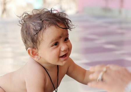 Portrait photo of a crawling baby boy with smiling face, Rajasthan Indiaの写真素材