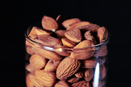black background in glass almond,almond in glass and beautiful background,close up view of almond,