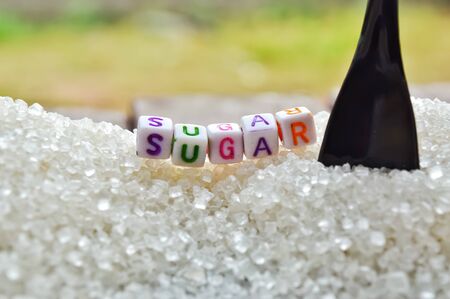 sugar writing text,sugar text,black spoon and white sugar with colorful textの写真素材