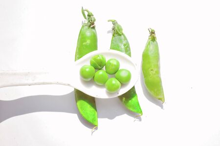 peas beans in white spoon,fresh peas,isolated peasの写真素材