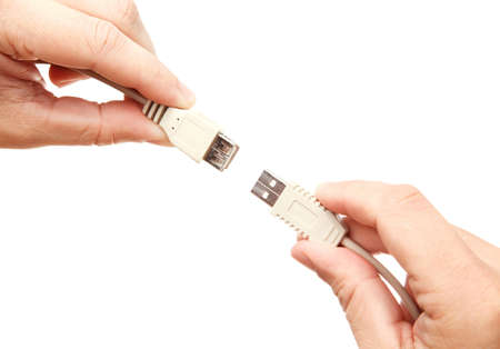 Hands connecting USB cablesの写真素材