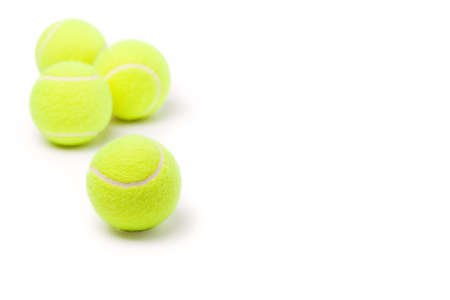 Four classic tennis balls isolated on white backgroundの写真素材