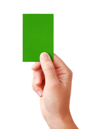 Hand of a judge showing positive decision symbol - green card, isolated on white の写真素材