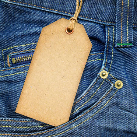 Vintage paper tag on blue denimの写真素材