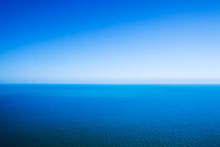 Idyllic abstract background - horizon line between calm sea and clear blue skyの写真素材