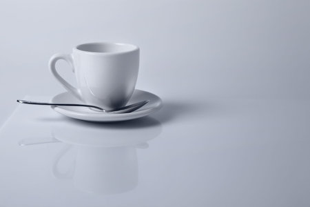 White empty coffee cup reflecting in white table surfaceの写真素材