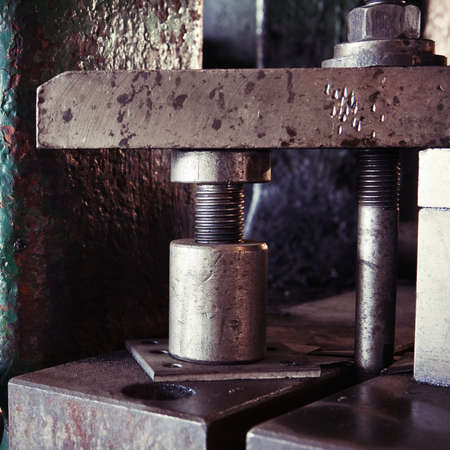 Huge screw bolt as a part of obsolete vintage heavy machinery for metal worksの写真素材