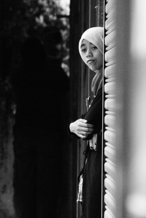 Young female teenager standing at entrance of an old shop in Malacca Townのeditorial素材