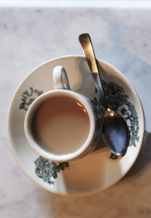 Milk tea served inside a traditional Chinese tea cup 