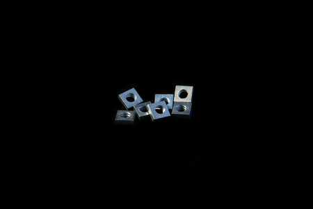 Set of machine screw square nuts isolated on black backgroundの写真素材