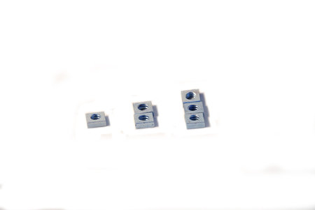 Six pieces of machine screw square nuts isolated on white background