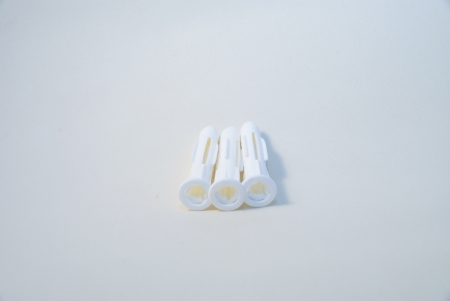 Three white screw wall plugsの写真素材