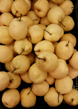 Stacked china gong pears for retail at the market