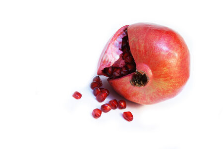 Fresh cut opened Pomegranate fruit or Buah Delima with seeds fallenの写真素材