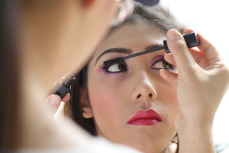 Young Indian girl having her face makeup doneの写真素材