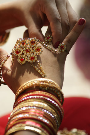 Young Indian girl wearing bangles and hand ring piece decoration