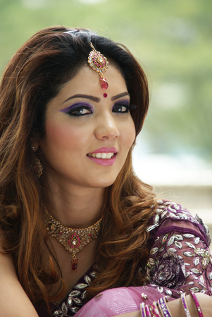 Young Indian girl in purple traditional saree clothingの写真素材