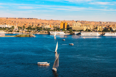 Sailboats sliding on Nile river  Felluca  traditional boat  of Egypt in Aswan s sunset のeditorial素材