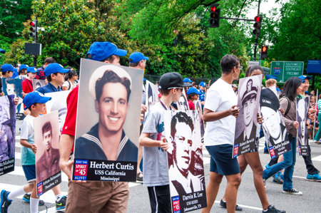 WASHINGTON, D C  - MAY 27, 2013  Participants of parade with portraits of the fallen heroes in...