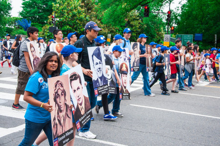 WASHINGTON, D C  - MAY 27, 2013  Participants of parade with portraits of the fallen heroes in...