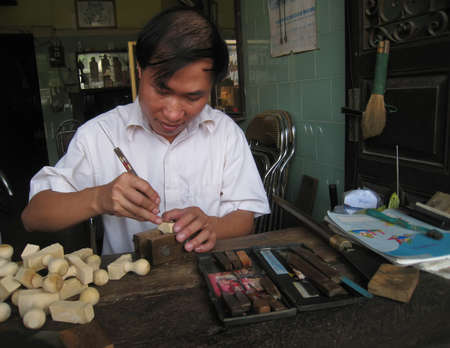 HAI DUONG, VIETNAM, July, 24: worker is doing the wooden seals in his shop July, 24, 2013 in Hai Duong, Vietnam.のeditorial素材