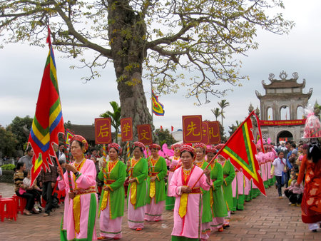 HAI DUONG, VIETNAM, March 29: group of people in traditional costumes and fan arrange letters in the...