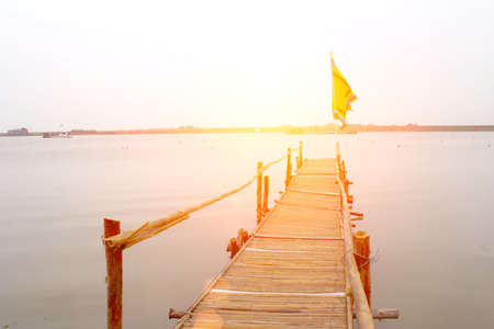 wooden road leading to the riverの写真素材