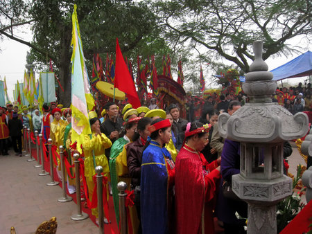 HAI DUONG, VIETNAM, March, 4: Group of people in traditional costume give gifts to the holy at Cao...