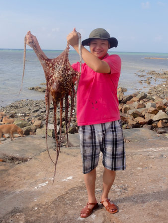                 KHANH HOA, VIETNAM, September, 17: man catch octopus at the sea on September, 17, 2013 in Khanh Hoa, Vietnam               のeditorial素材