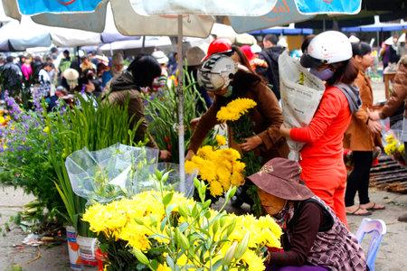 HAI DUONG, VIETNAM, APRIL, 10: Asian woman buying flowers in the market on April, 10  in Hai Duong, Vietnam. のeditorial素材