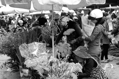 HAI DUONG, VIETNAM, APRIL, 10: Asian woman buying flowers in the market on April, 10  in Hai Duong, Vietnam. のeditorial素材