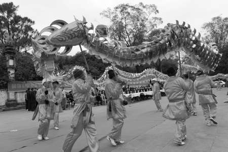 HAI DUONG, VIETNAM, February 14: a group of Asian people dance dragon in folk festivals on February 14, 2014 in Con Son pagoda, Hai Duong, Vietnam.のeditorial素材