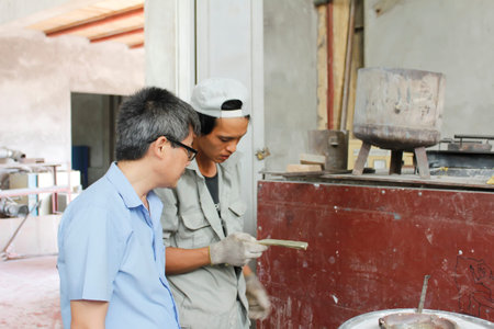 HAI DUONG, VIETNAM, August, 3: workers removal mold bronze casting products on August, 3, 2014 in Hai Duong, Vietnam.のeditorial素材