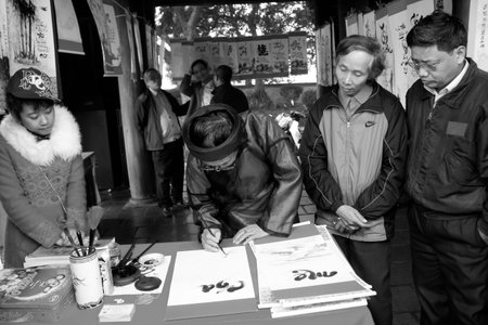 HAI DUONG, VIETNAM, March 18: calligraphers writing art letters for visitors on March, 18, 2014 in Hai Duong, Vietnam. These letters will hang in home for luck.のeditorial素材